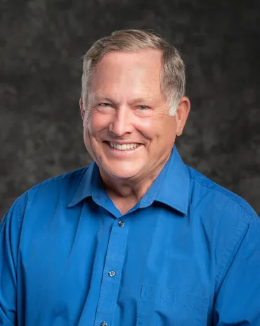 Dr. Kent Zerr, DMD, wearing a blue shirt, smiling at Lakeview Dental Center.