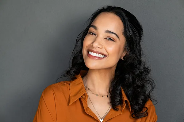 Beautiful Hispanic woman showing off her brilliant teeth with a smile