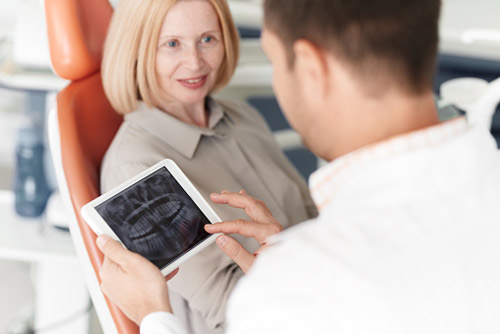 Older woman discussing dental implants with her dentist at Lakeview Dental Center in Salem, OR